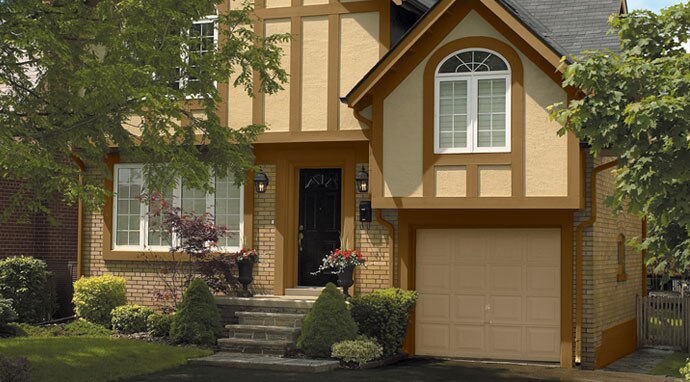 Garage doors painted in Benjamin Moore&rsquo;s everlasting (1038) enhance this home&rsquo;s overall style.