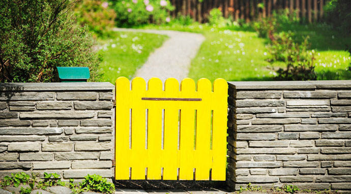 Benjamin Moore&rsquo;s banana yellow (2119-30) fence paint color instantly catches the eye.