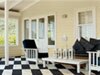 The checkerboard porch floor was created with Benjamin Moore&rsquo;s hale navy (HC-154) and mountain peak white (OC-121).