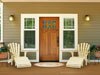 A porch floor painted with Benjamin Moore&rsquo;s richmond gold (HC-41) color creates a welcoming look.