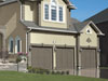Benjamin Moore&rsquo;s paint color dolphin (AF-715) gives these garage doors a sophisticated look.