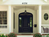 A front door painted with Benjamin Moore&rsquo;s baby seal black (2119-30) instantly catches the eye.