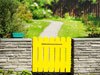 Benjamin Moore&rsquo;s banana yellow (2119-30) fence paint color instantly catches the eye.
