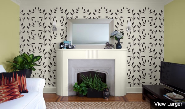 A wall stencilled with Benjamin Moore's Vineyard Wall Tattoo frames a fireplace.