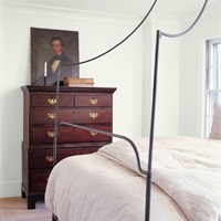 A bedroom painted pale yellow