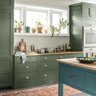 A modern farmhouse kitchen features built-in cabinetry and ovens, along with a kitchen island.