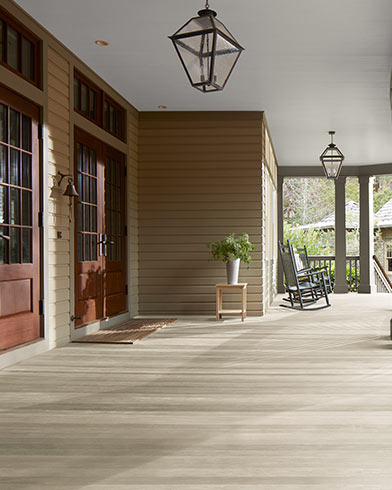 A spacious closed-in porch features a beautiful Bleached Gray ES-78 Woodluxe® Translucent stained floor.