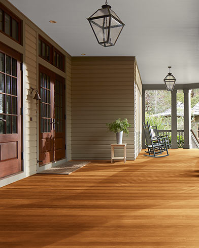 Grande véranda couverte avec magnifique plancher enduit de teinture Woodluxe au fini translucide de couleur Teck ES-30.