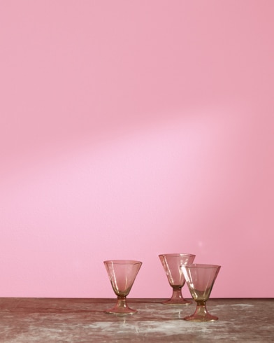 Three glass cups in front of a Full Bloom-painted wall.