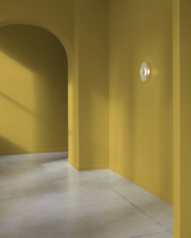 An arched hallway in a modern home is painted Dragonwell.