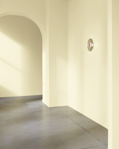 An arched hallway in a modern home is painted Greenmount Silk.