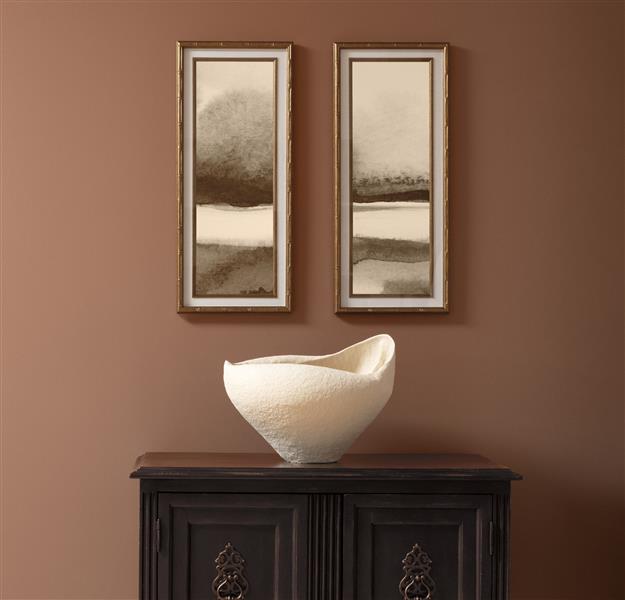 A hallway vignette with a dark wooden cabinet and white vase. Walls are painted in Antique Copper 1169, part of the Benjamin Moore Colour Trends 2027 collection.