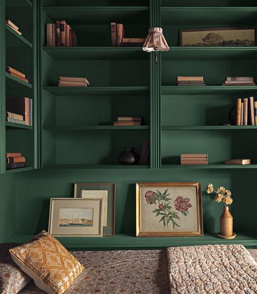 Built in shelving colour drenched in Webster Green HC-130 next to a bed with floral quilt.