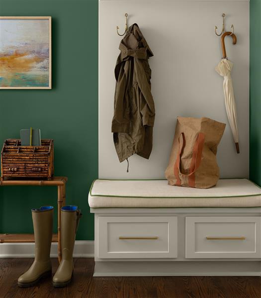A hallway vignette with Webster Green HC-130 on the walls and White Down OC-131 on the joinery, both part of the Benjamin Moore Colour Trends 2027 collection.